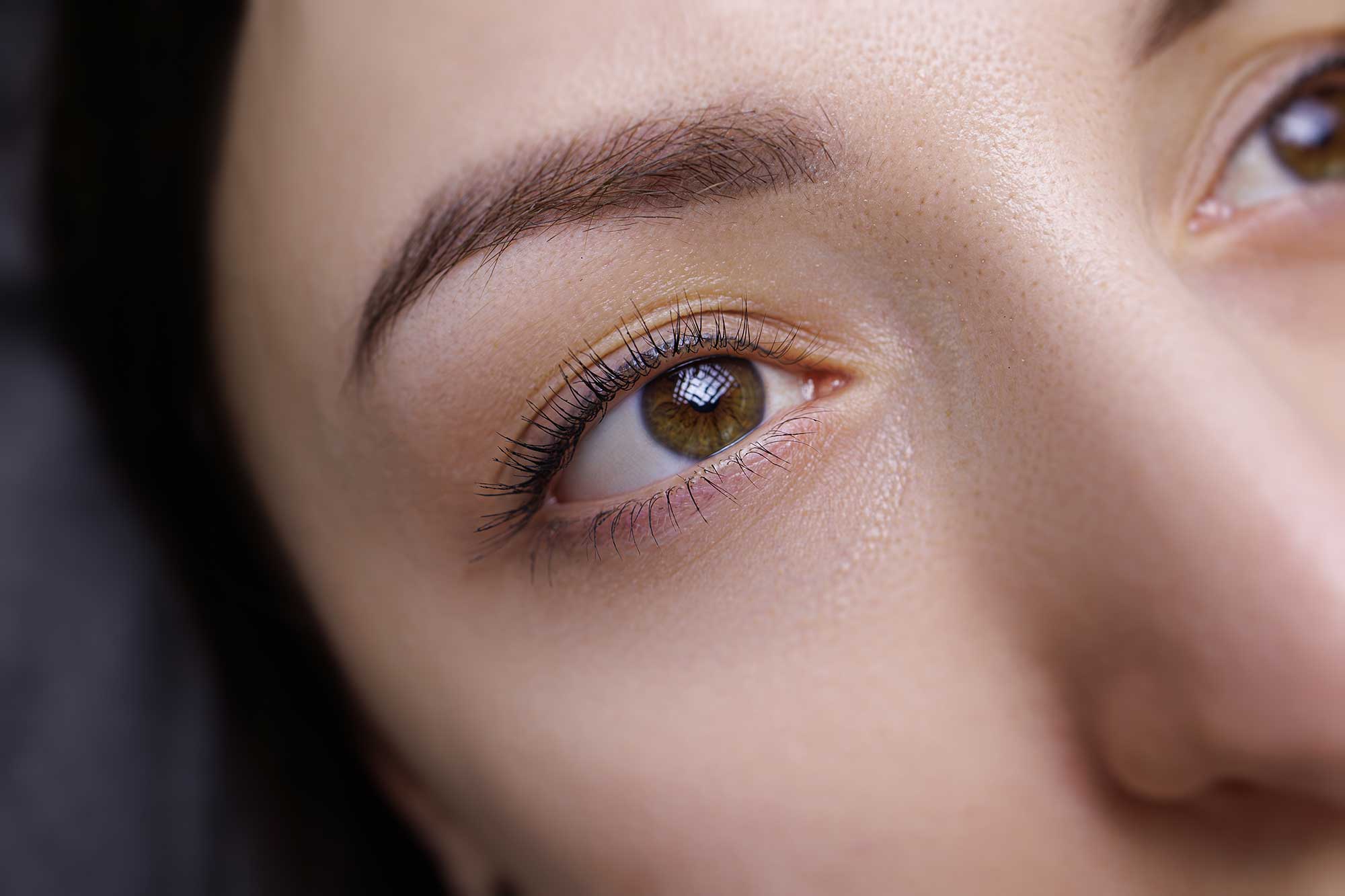 Close-up of beautifully shaped eyebrows after a professional threading session