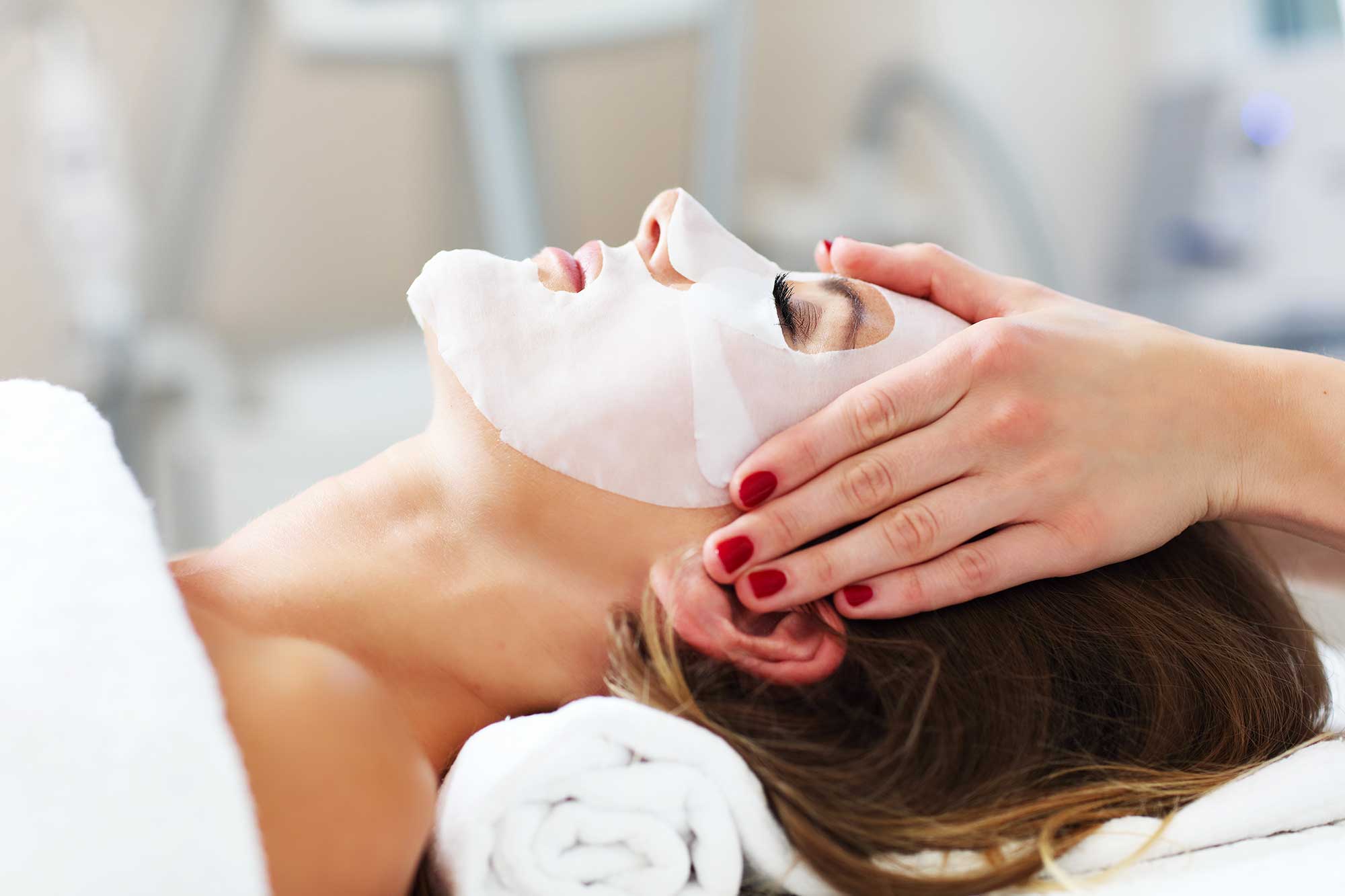Facial treatment with nourishing mask applied for glowing skin rejuvenation.